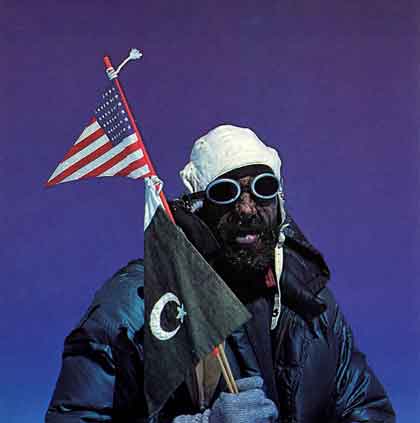 
Andy Kauffman holds the American flag and the Pakistani flag on the summit of Gasherbrum I (Hidden Peak) after the first ascent on July 5, 1958 - A Walk In The Sky book
